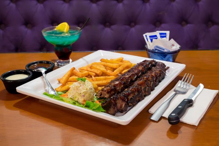 Full slab of ribs with fries and a cocktail